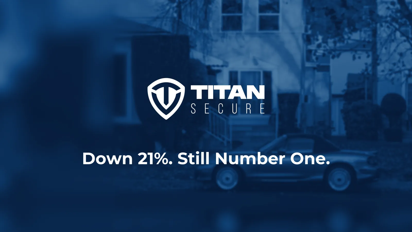 A car parked on a quiet Southern California street in evening light, with the Titan Secure logo and the headline Down 21%. Still Number One.